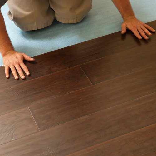 Person Laying Click-Together Flooring Planks